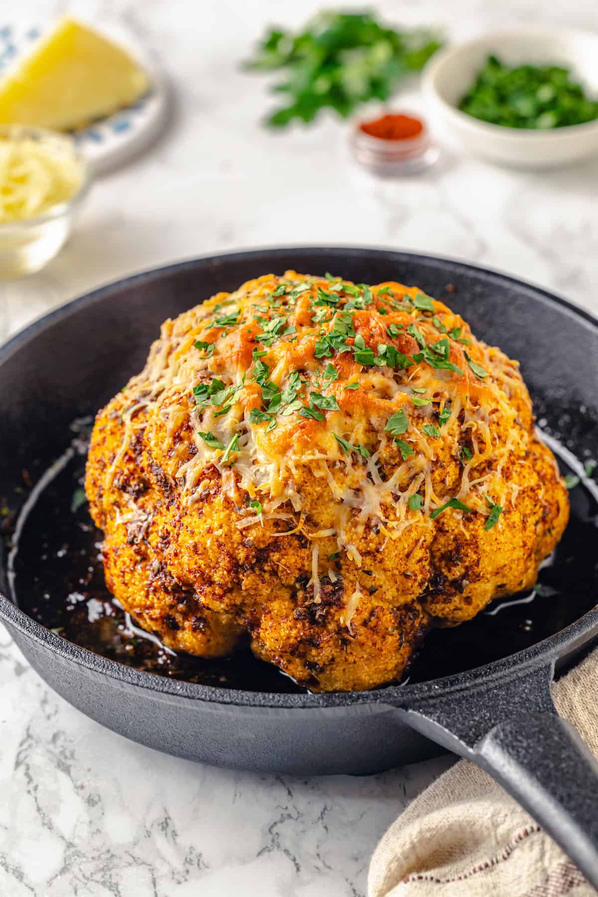 Whole roasted cauliflower cooked in cast iron skillet