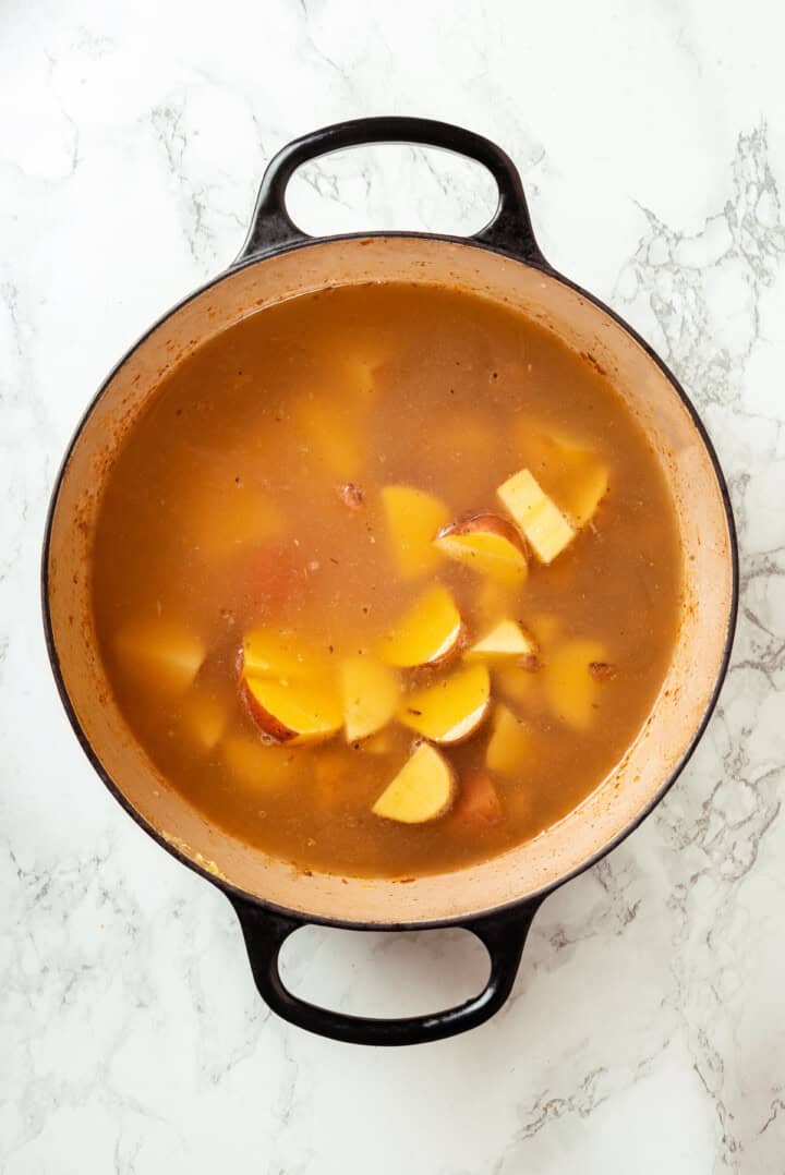 Potatoes cooking in pot of soup