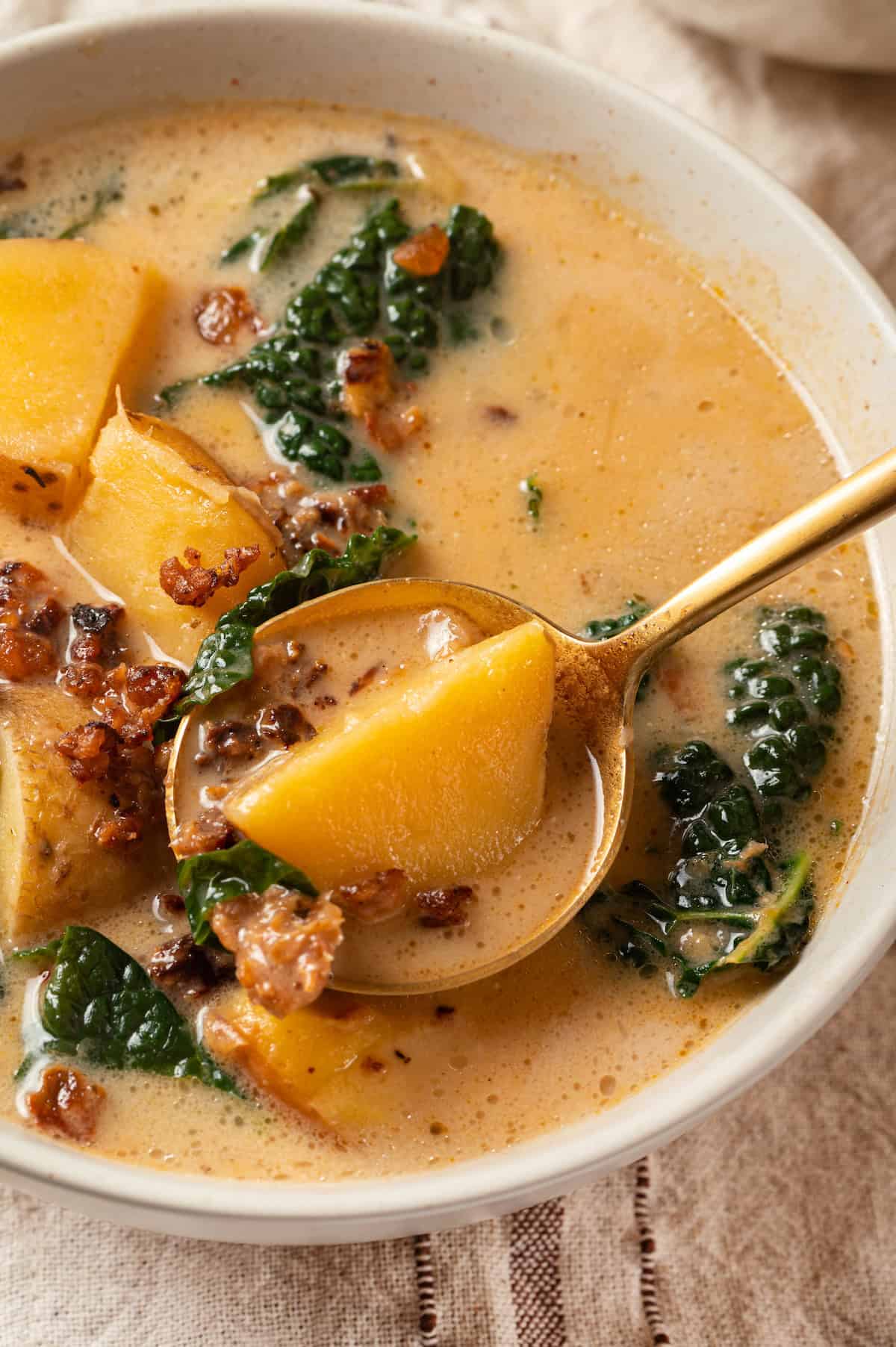 Spoonful of zuppa toscana in bowl