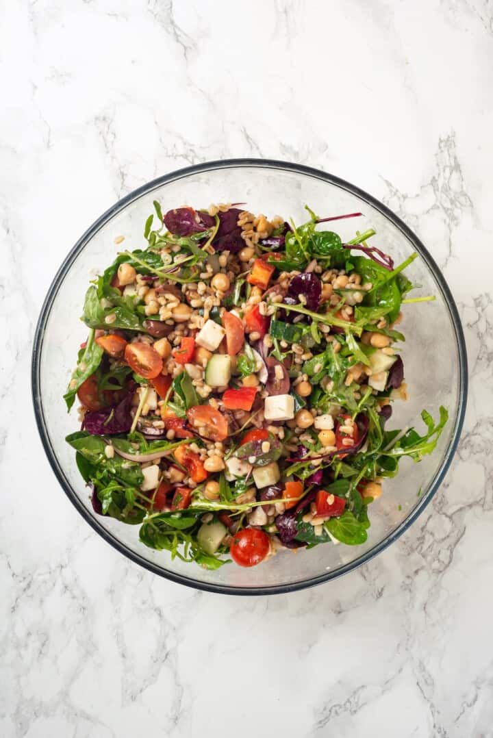 Overhead view of farro salad in glass bowl