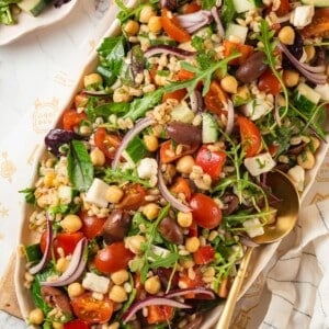 Top-down view of farro salad with vegetables, chickpeas, and greens