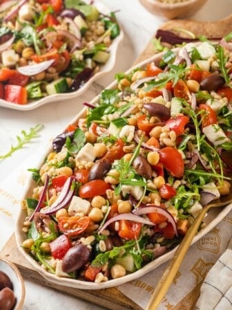 Platter of Greek farro salad with serving spoon