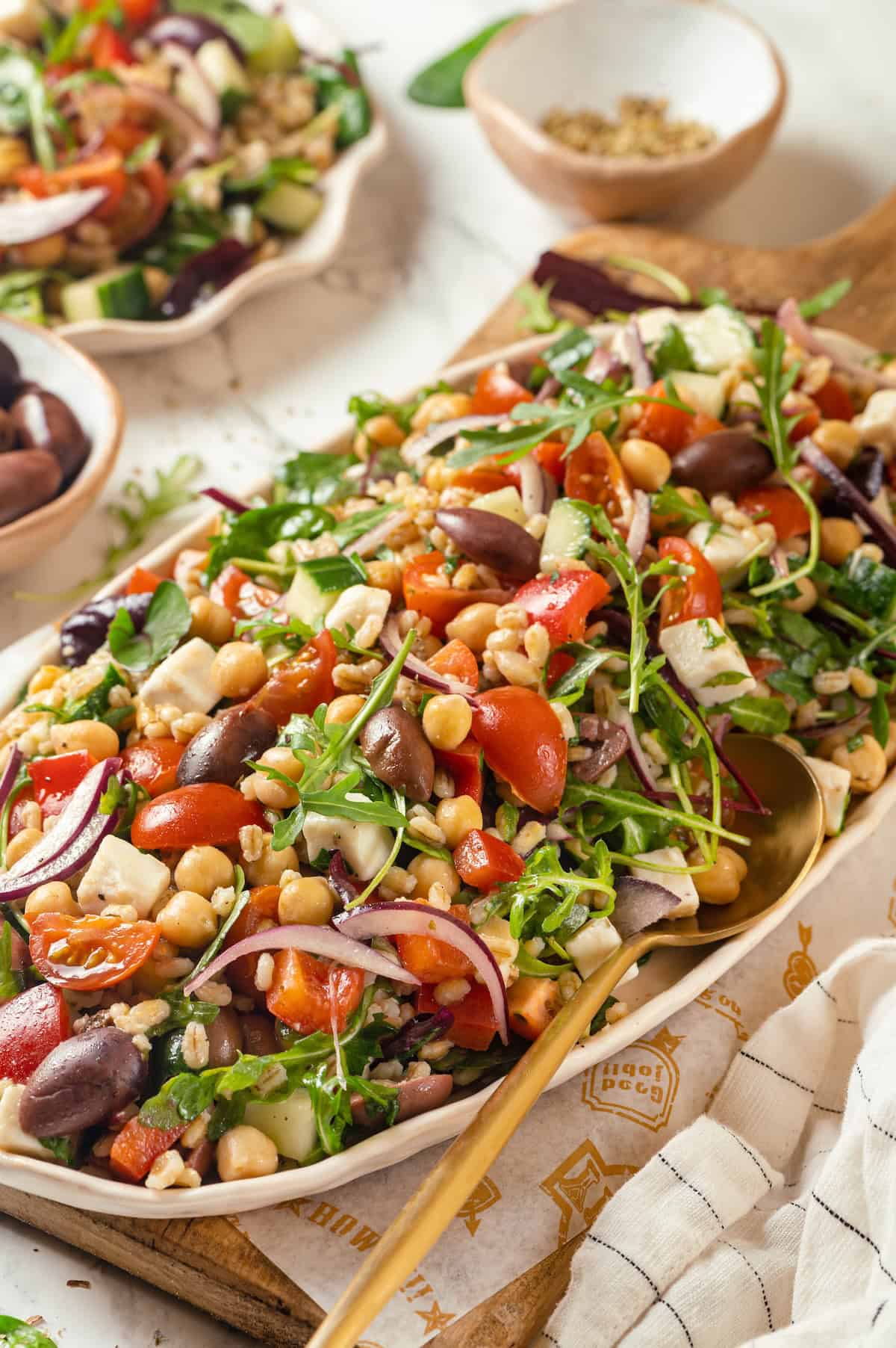 Platter of Greek farro salad with serving spoon