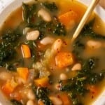 Overhead view of kale soup in bowl with spoon