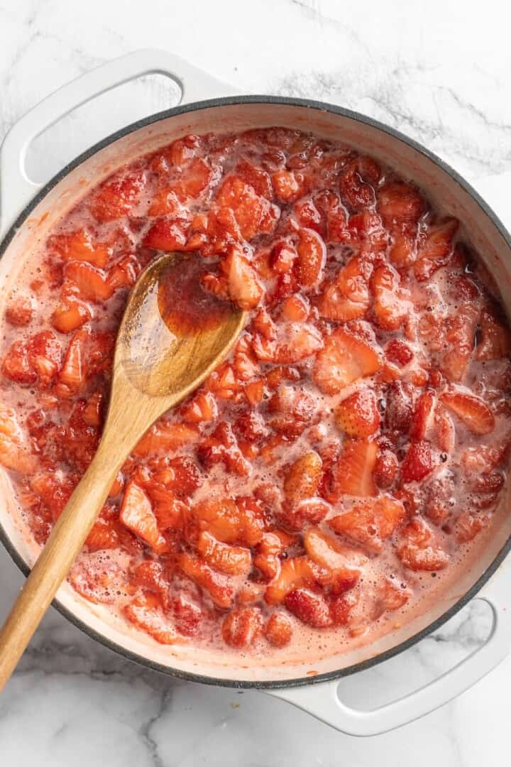 Strawberries cooking in pot for jam
