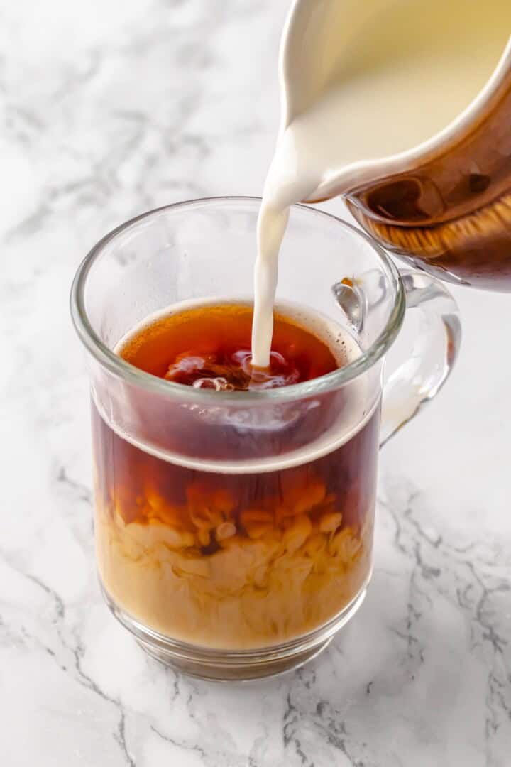 Pouring milk into dirty chai latte