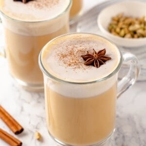 Mugs of homemade dirty chai latte with spices for garnish