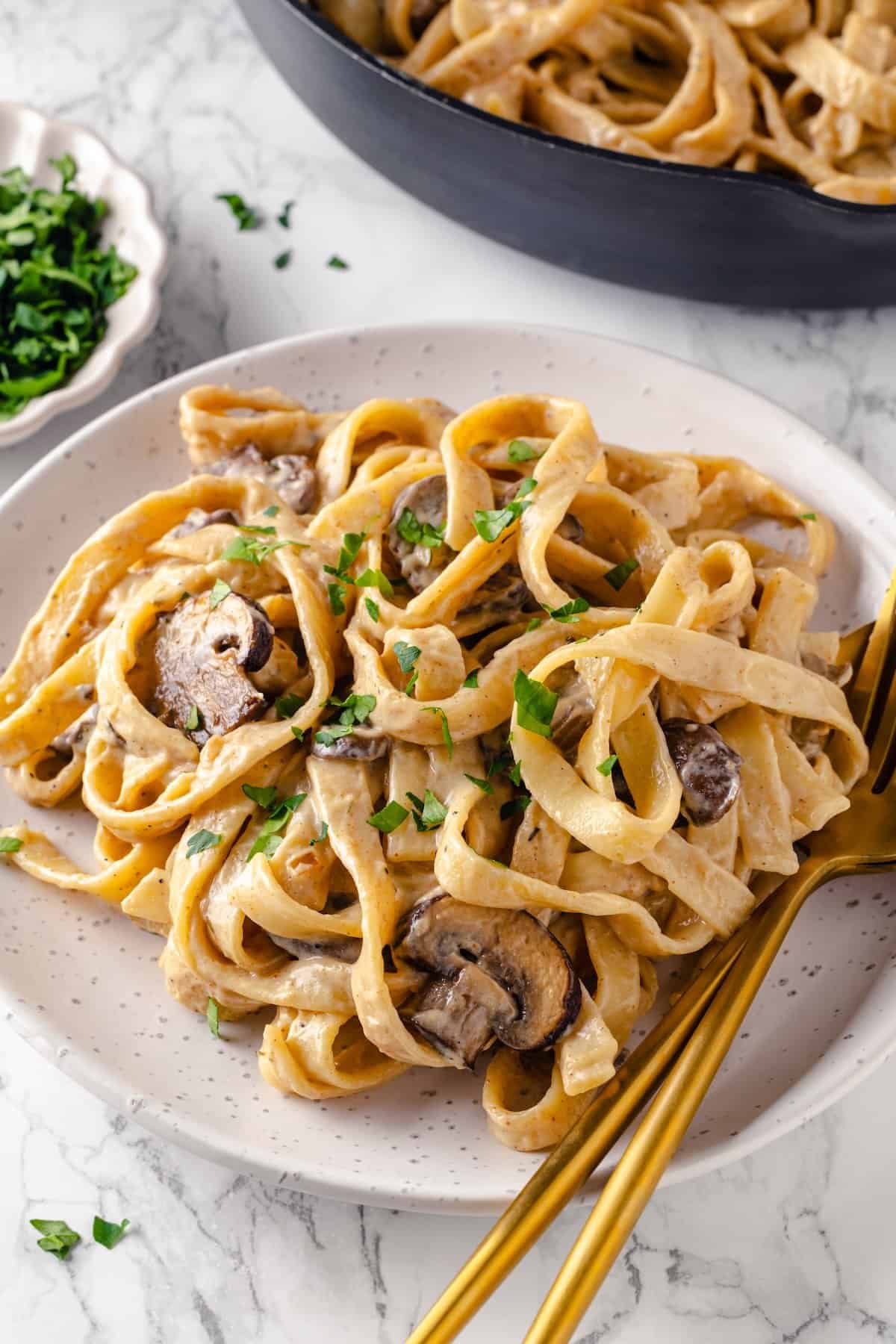 Vegan mushroom stroganoff on plate with fork and spoon