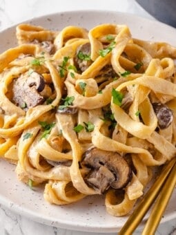 Plate of vegan mushroom stroganoff with fork and spoon