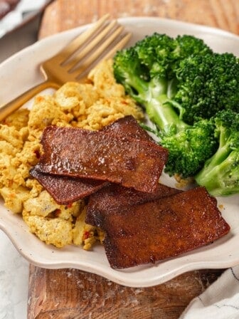 Plate with vegan scramble, broccoli, and tofu bacon
