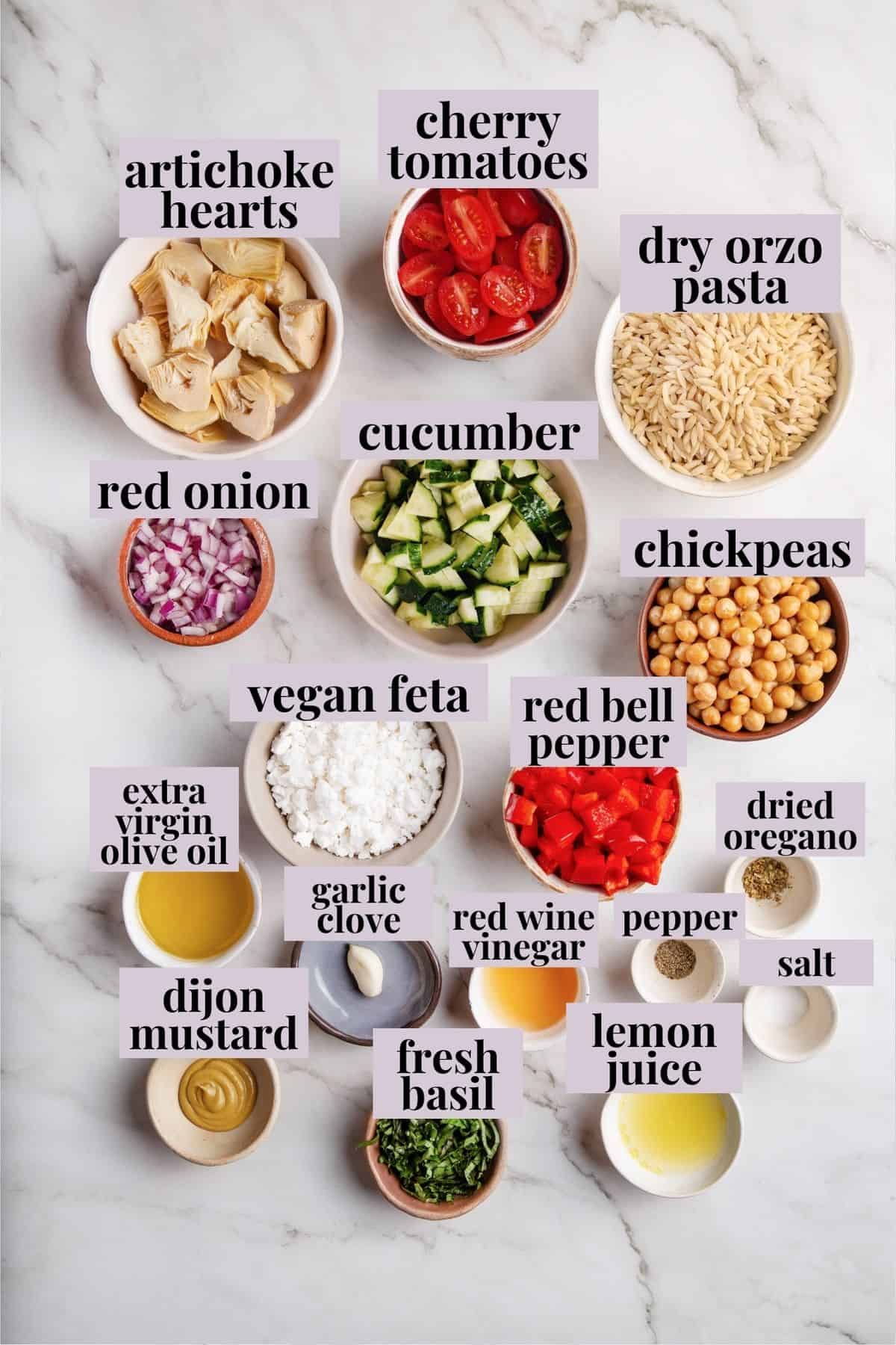 Overhead view of orzo pasta salad ingredients with labels