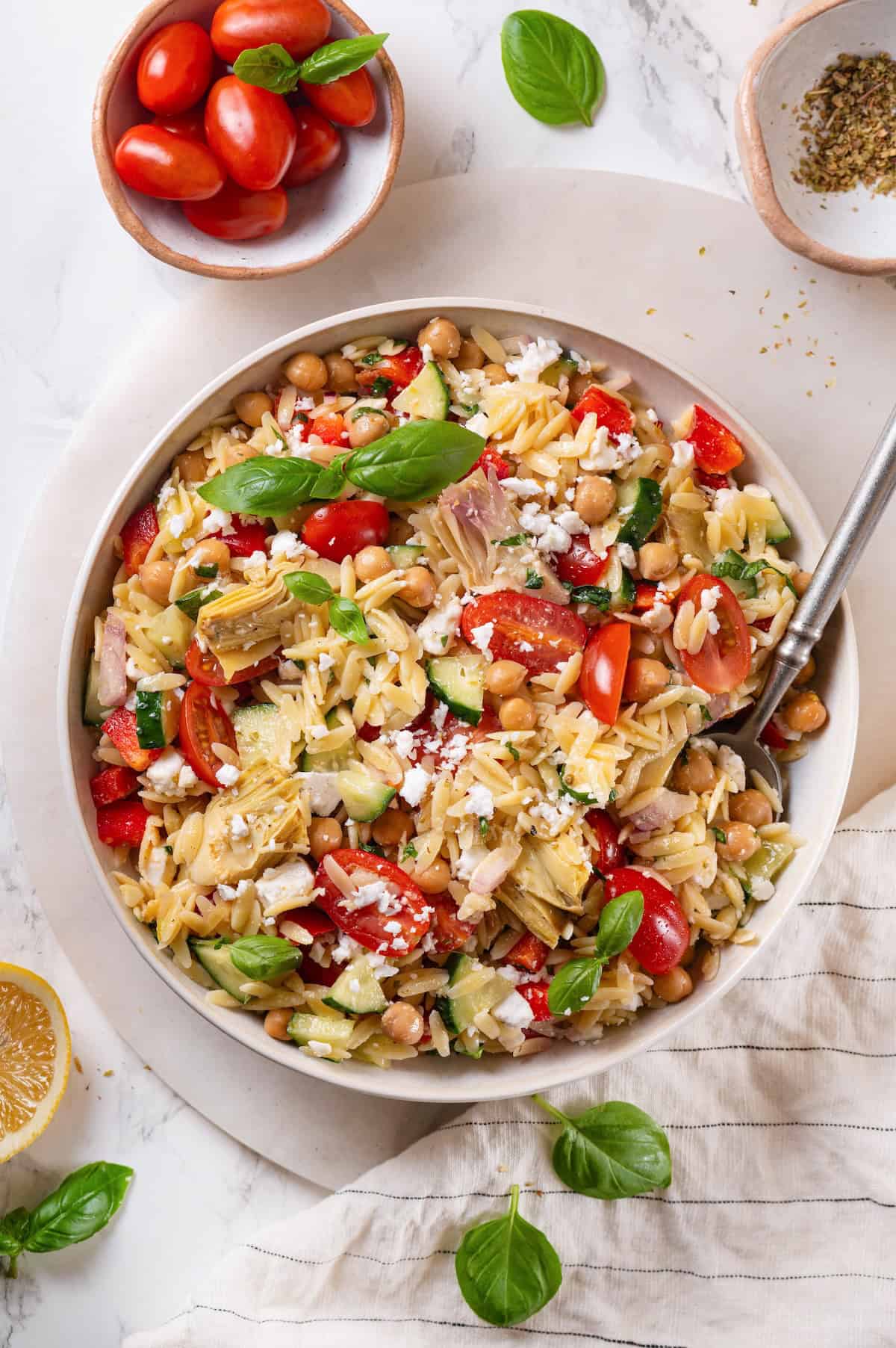 Overhead view of vegan orzo pasta salad with spoon