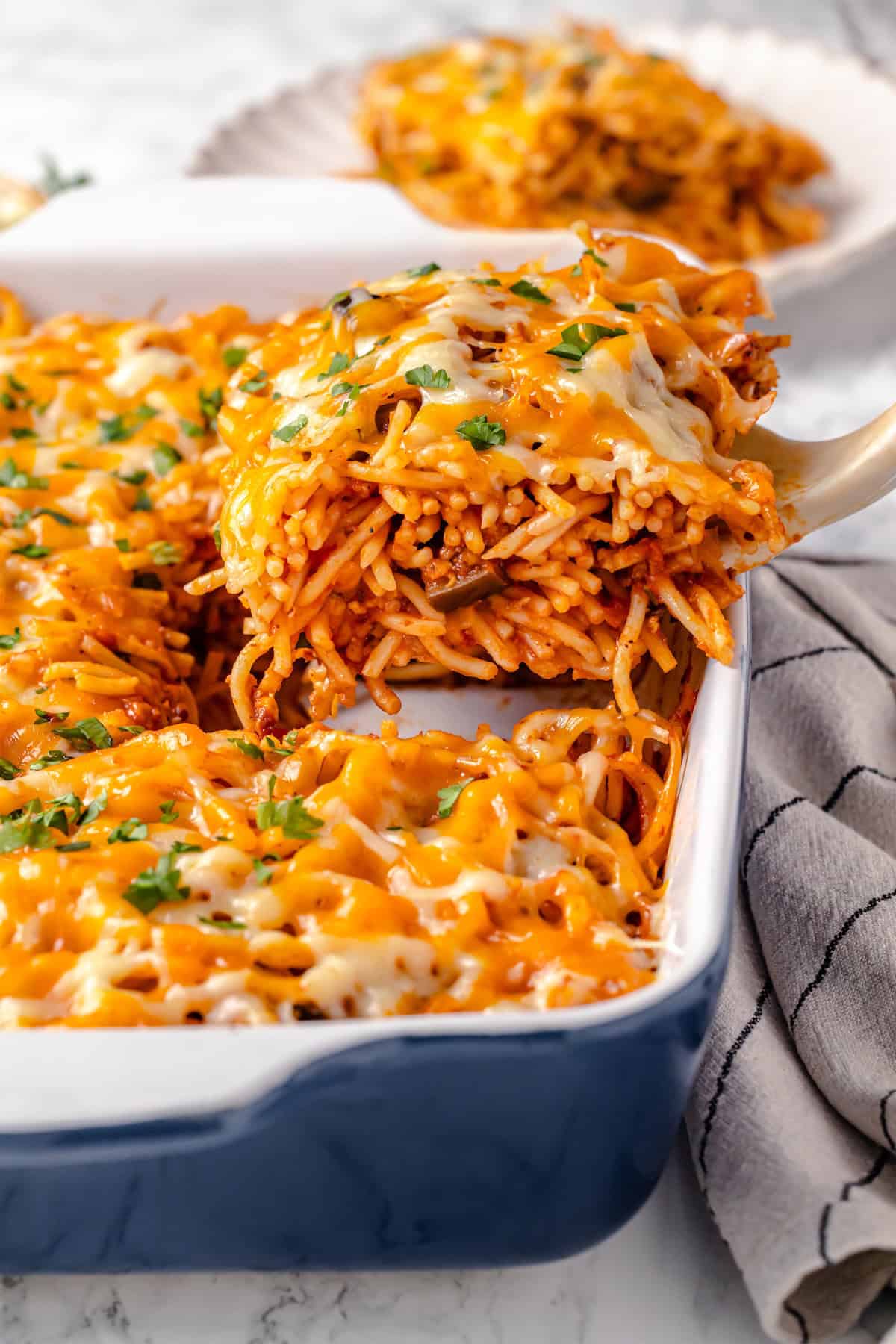 Lifting serving of baked spaghetti out of casserole dish