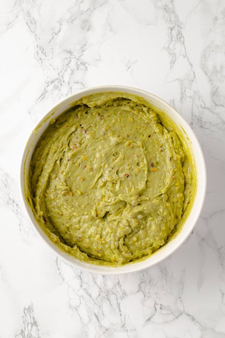 Overhead view of pistachio cake batter in bowl