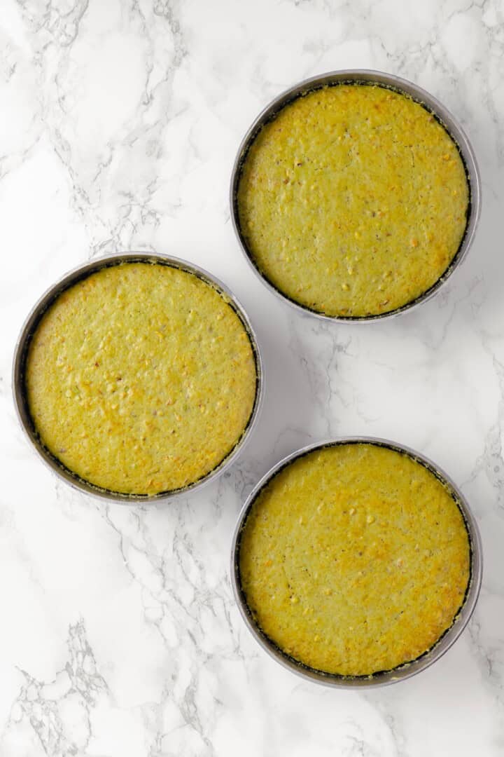 Overhead view of 3 round pans of pistachio cake