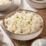 Bowl of Instant Pot jasmine rice with green onions for garnish