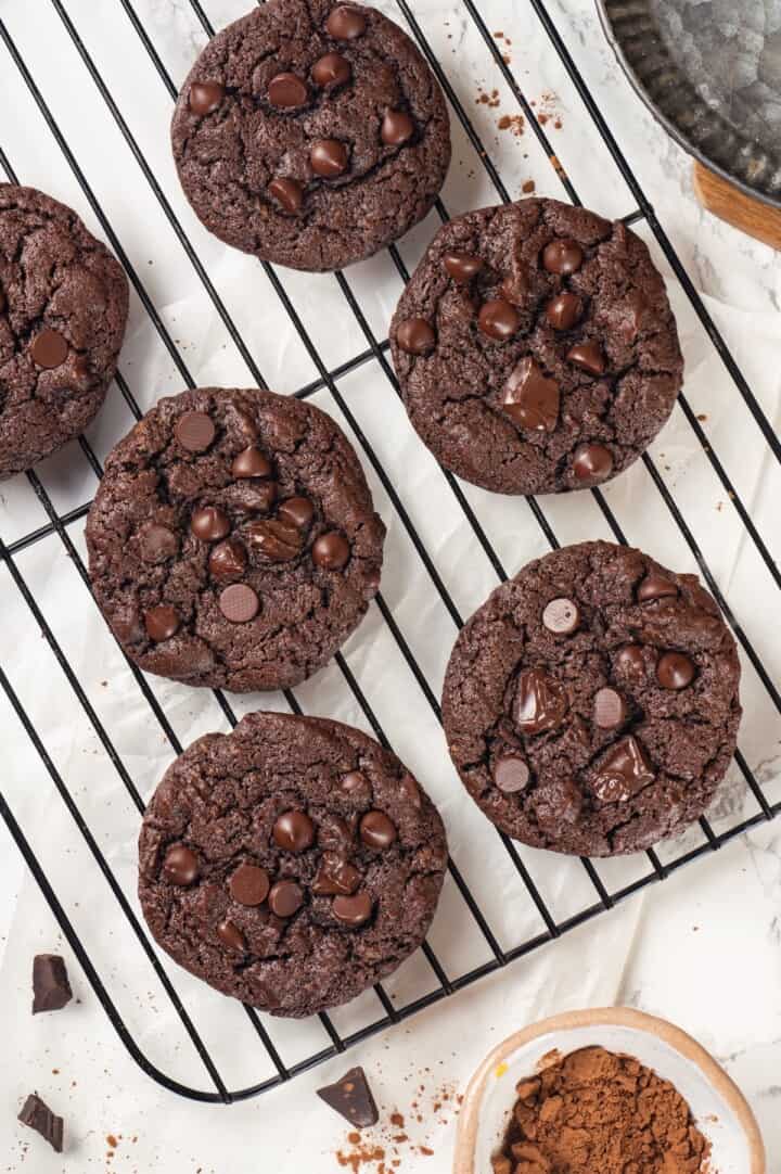Overhead view of double chocolate chunk cookies cooling on wire rack