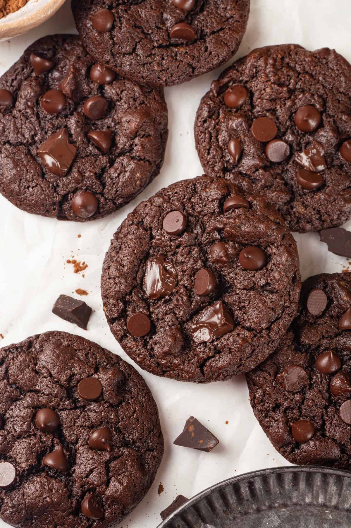 Overhead view of double chocolate chunk cookies on parchment paper