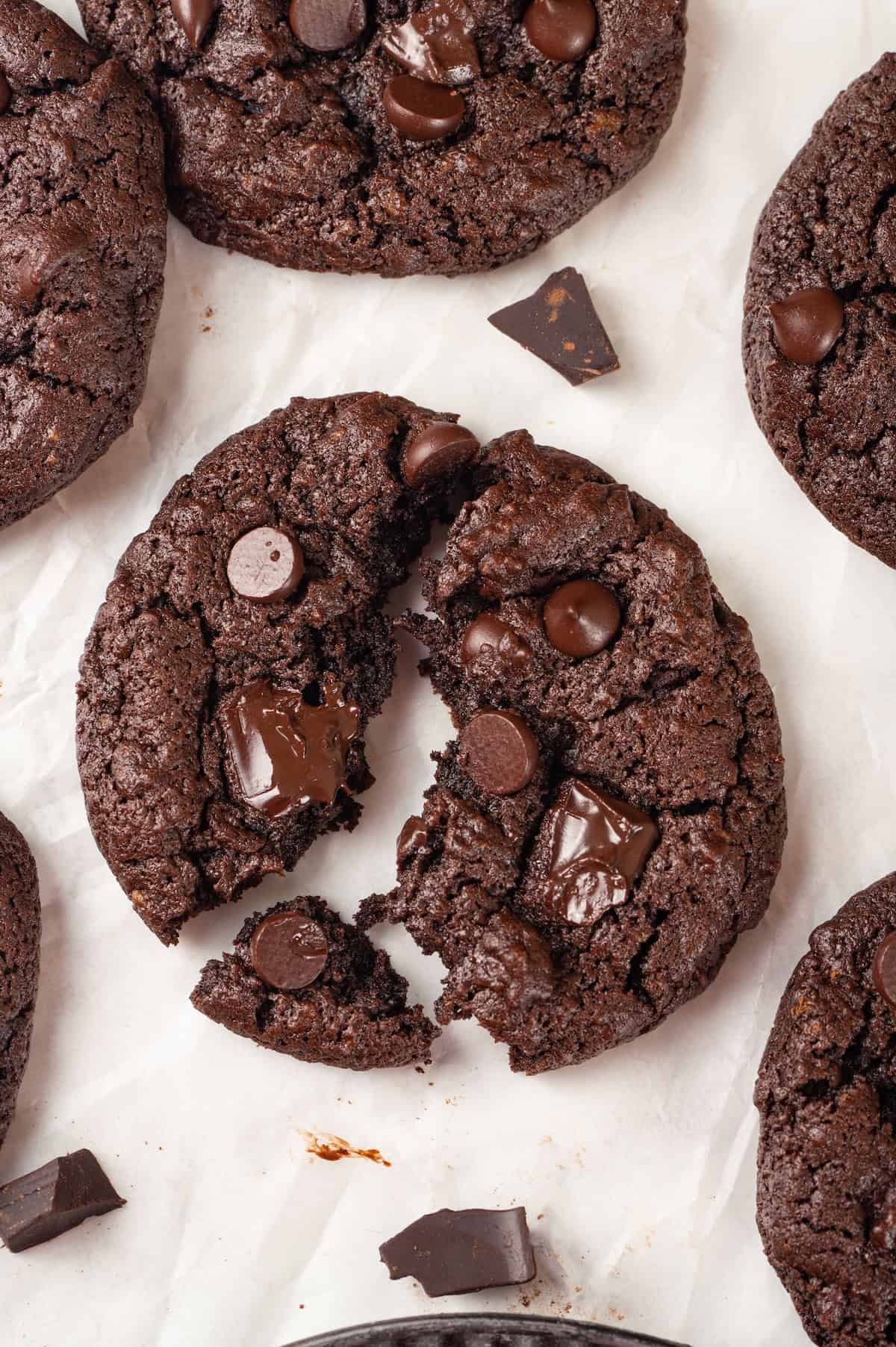 Overhead view of double chocolate chunk cookie broken into 3 pieces