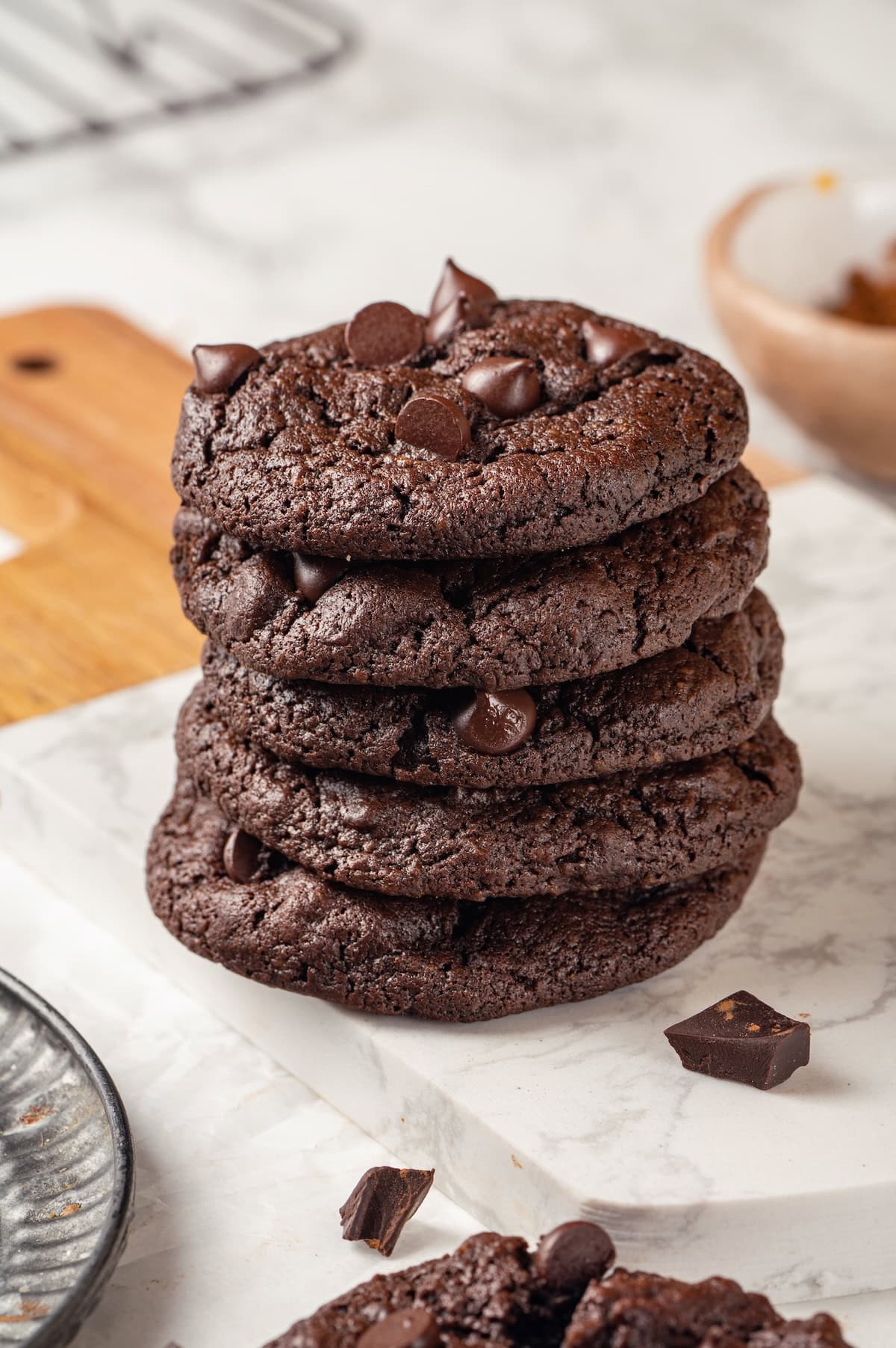 Stack of 5 double chocolate chunk cookies on marble board