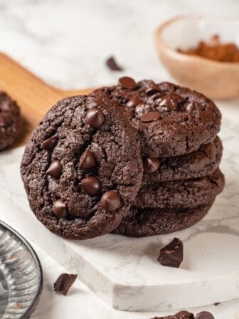 Stack of 4 double chocolate chunk cookies with a fifth leaning against them