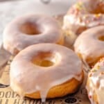 Homemade air fryer donuts on parchment-lined board