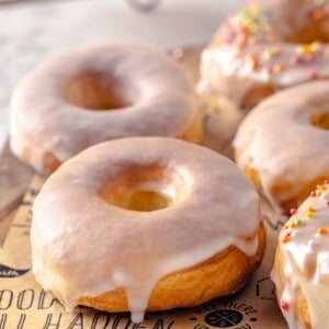 Homemade air fryer donuts on parchment-lined board