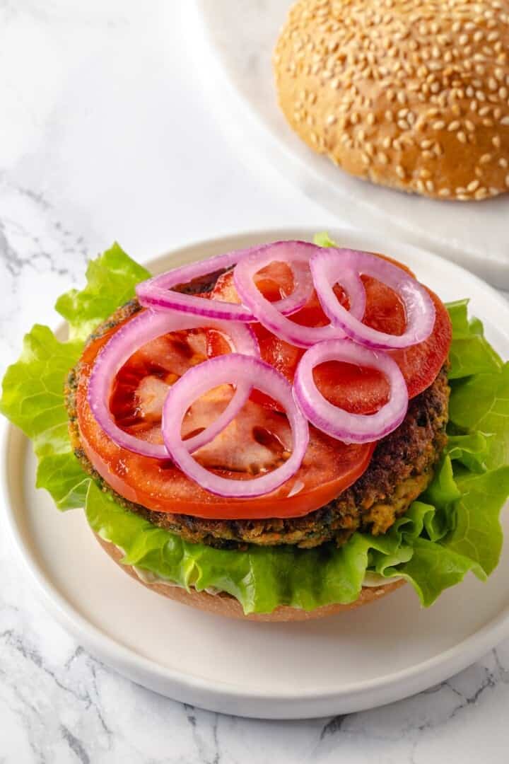 Pickled red onions added to falafel burger