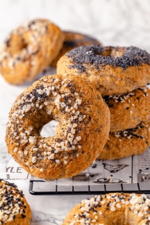 Stack of 3 gluten-free bagels with another leaning against it