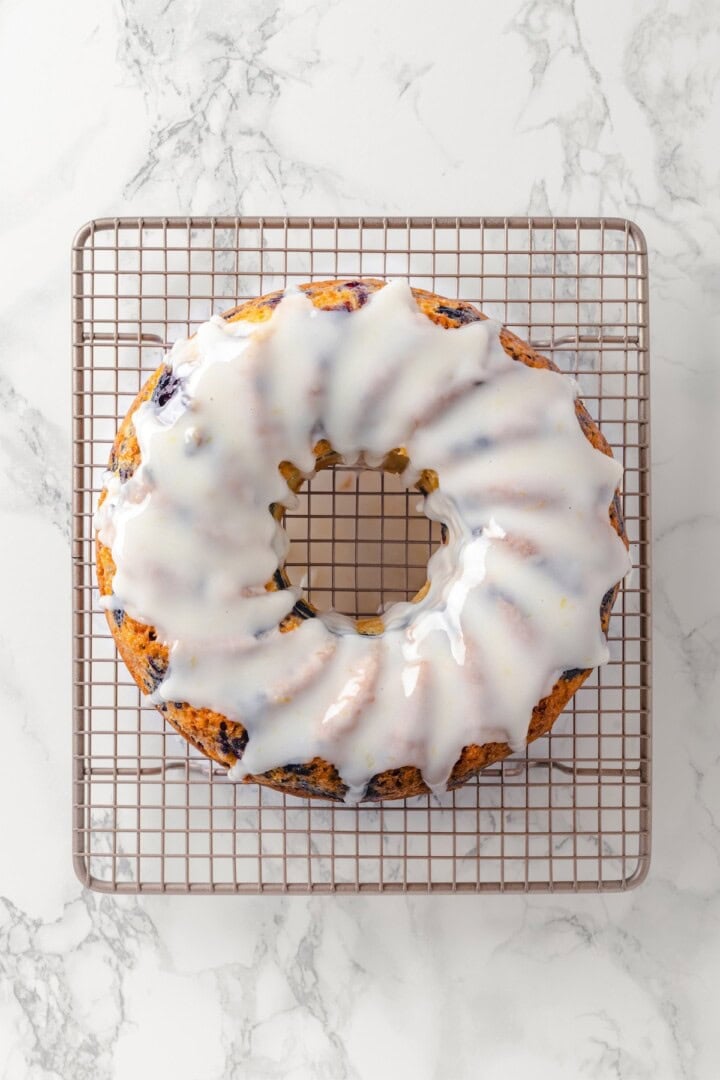 Overhead view of lemon blueberry Bundt cake on wire rack