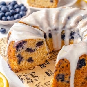 Sliced lemon blueberry Bundt cake on platter with a few pieces removed