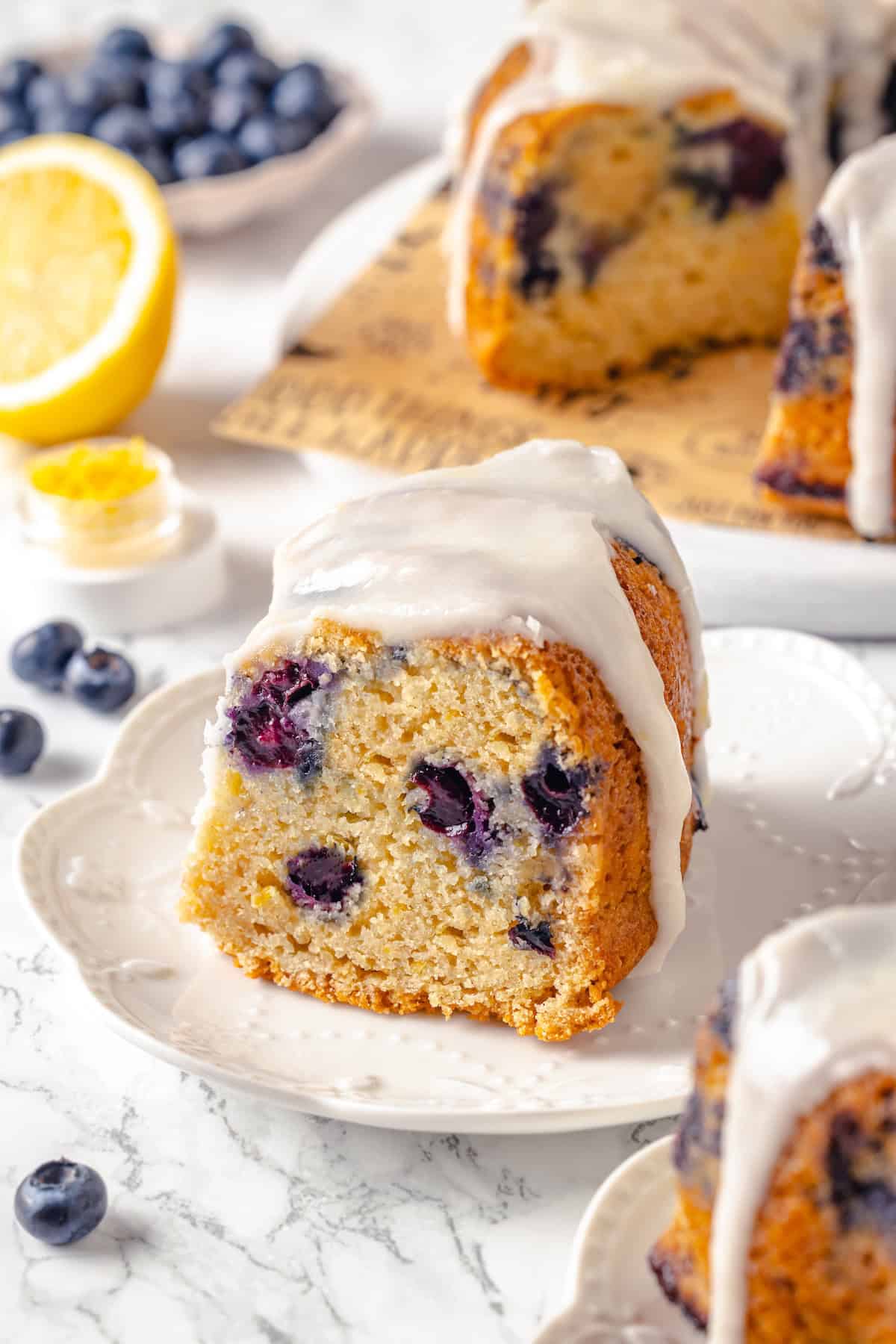 Slice of lemon blueberry Bundt cake on white plate