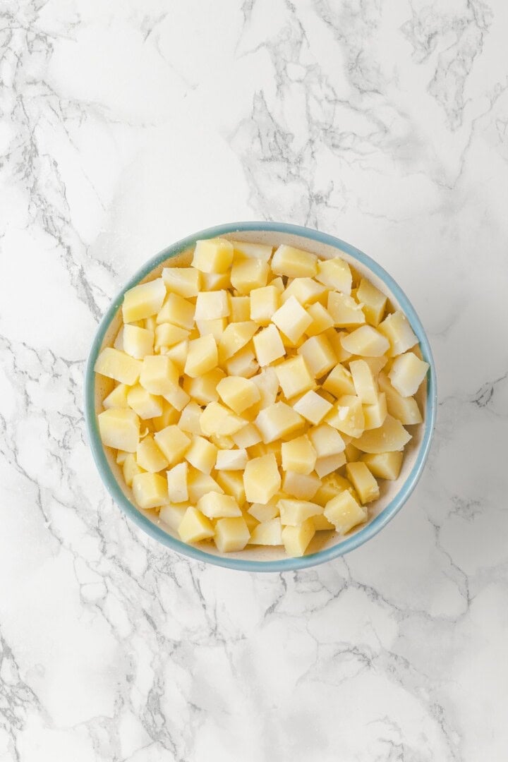 Overhead view of potato chunks in bowl