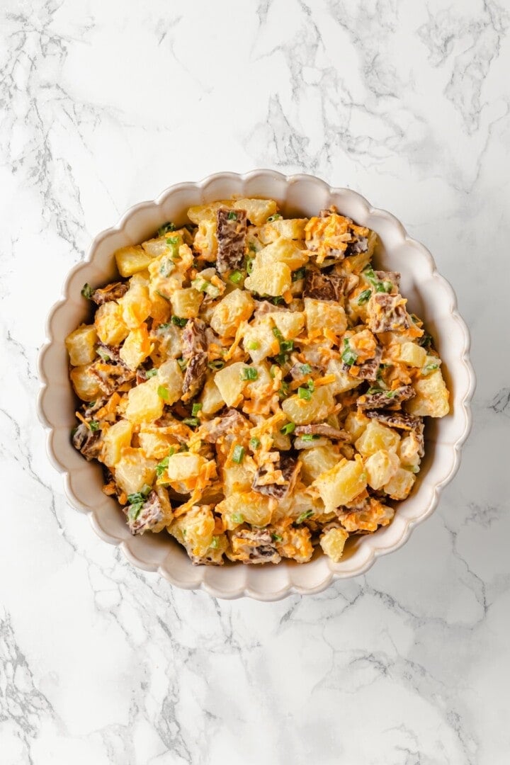 Overhead view of loaded baked potato salad in bowl