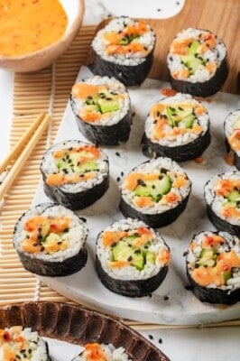 Avocado sushi rolls arranged on marble serving board