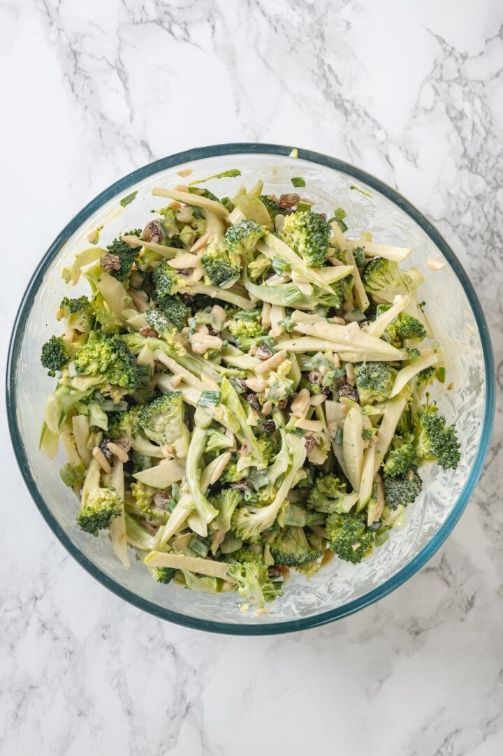 Overhead view of broccoli slaw in glass mixing bowl