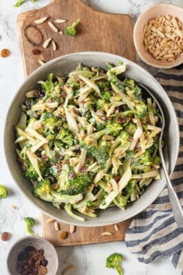 Overhead view of broccoli slaw in bowl with spoon