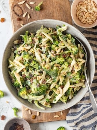 Overhead view of broccoli slaw in bowl with spoon