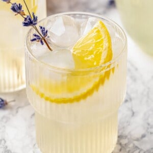 Lavender lemonade in glass with lemon slice and lavender sprig