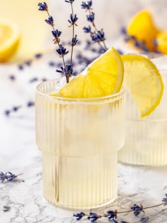 Two glasses of lavender lemonade with lemon slices and lavender sprigs