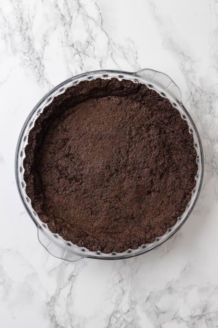 Overhead view of Oreo pie crust in glass pie plate