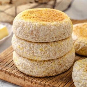 Stack of 3 gluten-free English muffins on cutting board