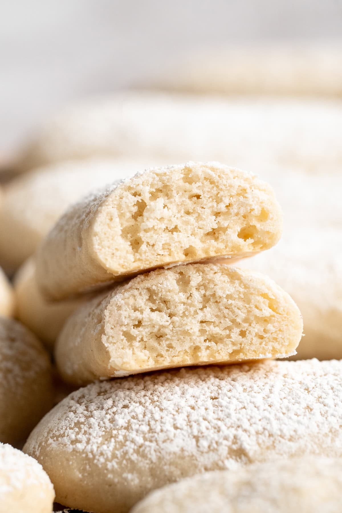 Closeup of vegan ladyfinger broken in half to show light, airy texture