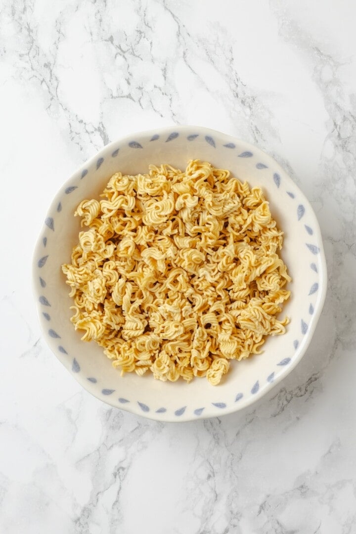 Overhead view of ramen noodles broken into pieces in bowl