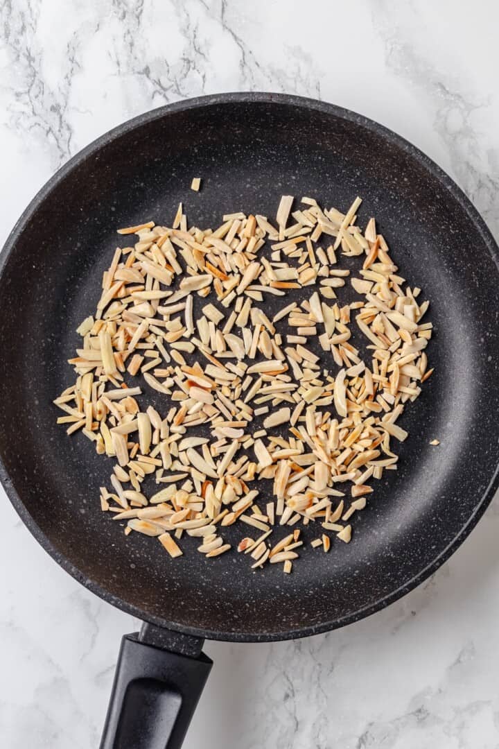 Overhead view of toasted almonds in skillet