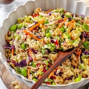 Wooden spoon scooping ramen noodle salad from bowl