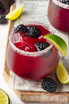 Salted glass with blackberry margarita and fresh berries for garnish