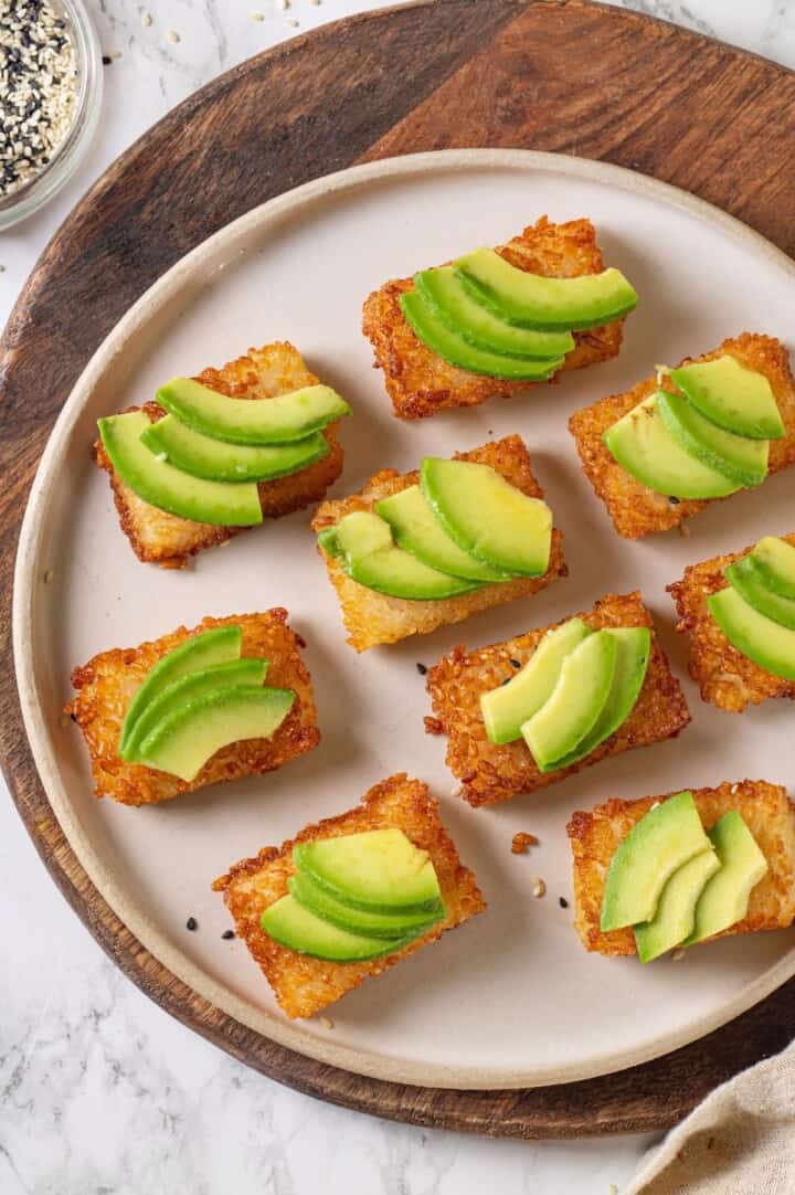 Overhead view of crispy rice cakes topped with avocado slices