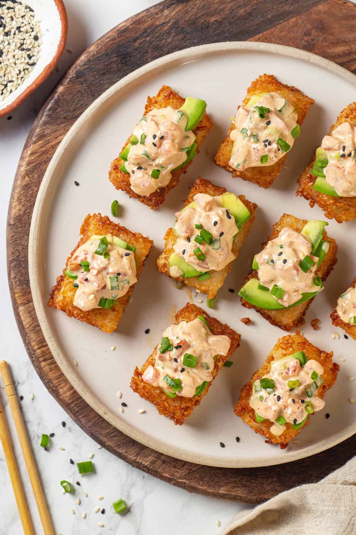 Overhead view of crispy rice cakes topped with spicy vegan tuna