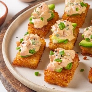 Plate of crispy rice cakes topped with creamy vegan tuna